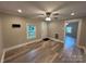 Cozy living room featuring wood-look floors and a ceiling fan at 111 Rose St, Mount Holly, NC 28120