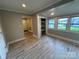 Open living area with large windows, wood-look flooring and an attached closet at 111 Rose St, Mount Holly, NC 28120