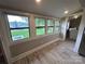 Living area with updated flooring and large windows providing natural light at 111 Rose St, Mount Holly, NC 28120