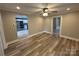 Open living room featuring wood-look floors and a ceiling fan at 111 Rose St, Mount Holly, NC 28120