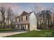 Two-story home with a well-maintained lawn, black shutters, neutral paint, and a paved driveway at 1117 Thayer Glen Ct, Charlotte, NC 28213