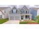 Charming two-story home featuring a two-car garage and landscaped front yard at 112 Fordingbridge Ln, Mooresville, NC 28115