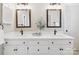 Bathroom with double sinks, white cabinets, and black hardware at 1140 Iverleigh Trl, Charlotte, NC 28270