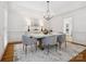 Dining room with elegant chandelier, stylish chairs, and a decorative rug at 1140 Iverleigh Trl, Charlotte, NC 28270