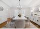 Bright dining room featuring a chandelier, side board, and white trim at 1140 Iverleigh Trl, Charlotte, NC 28270