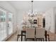 Bright dining area features white cabinetry, stainless appliances, and view to the kitchen at 1140 Iverleigh Trl, Charlotte, NC 28270