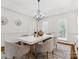 Formal dining area with chandelier, a large table, and wainscoting at 1140 Iverleigh Trl, Charlotte, NC 28270