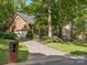 Traditional brick home with mature landscaping and a paved driveway at 1140 Iverleigh Trl, Charlotte, NC 28270