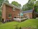 Brick house featuring a spacious deck, mature landscaping and backyard at 1140 Iverleigh Trl, Charlotte, NC 28270