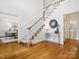 Elegant foyer with hardwood floors, a staircase, and tasteful decor at 1140 Iverleigh Trl, Charlotte, NC 28270