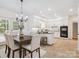 Bright kitchen and dining area features white cabinetry, stainless appliances and stylish accents at 1140 Iverleigh Trl, Charlotte, NC 28270