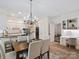 Bright kitchen and dining area features white cabinetry, stainless appliances and stylish accents at 1140 Iverleigh Trl, Charlotte, NC 28270