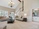 Spacious living room with vaulted ceilings, staircase, and stylish furniture at 1140 Iverleigh Trl, Charlotte, NC 28270