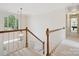 Open staircase featuring carpeted steps and large window providing ample natural light at 1140 Iverleigh Trl, Charlotte, NC 28270