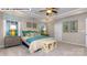 Spacious primary bedroom with a tray ceiling, ceiling fan, and plenty of natural light at 135 Asmodean Ln, Troutman, NC 28166