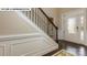 Bright foyer with hardwood floors, wainscoting, and an elegant staircase at 135 Asmodean Ln, Troutman, NC 28166