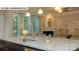 Modern kitchen featuring a granite countertop island, stainless steel sink, and views of the living area at 135 Asmodean Ln, Troutman, NC 28166