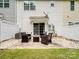 Relaxing back patio with outdoor seating surrounded by a small, fenced-in backyard at 13909 Singleleaf Ln, Charlotte, NC 28278