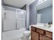 This bathroom features a tub/shower combo with sliding doors and a single sink vanity at 13909 Singleleaf Ln, Charlotte, NC 28278