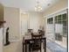 Bright dining area featuring tile floors, a modern light fixture, and sliding door access to the patio at 13909 Singleleaf Ln, Charlotte, NC 28278