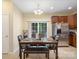 Cozy dining area featuring a dark wood table, stainless steel appliances, and natural light at 13909 Singleleaf Ln, Charlotte, NC 28278