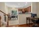 Bright dining area with a view, seamlessly connected to an open kitchen and staircase at 13909 Singleleaf Ln, Charlotte, NC 28278