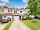 Charming townhome with a well-maintained lawn, driveway, and inviting entrance at 13909 Singleleaf Ln, Charlotte, NC 28278