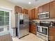 View of the kitchen with stainless steel appliances and a door to the backyard at 13909 Singleleaf Ln, Charlotte, NC 28278
