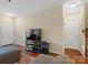 Bright living area featuring hardwood floors, neutral walls, and a staircase leading to the upper level at 13909 Singleleaf Ln, Charlotte, NC 28278