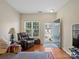 Inviting living room with hardwood floors, a comfortable recliner, and an open entrance at 13909 Singleleaf Ln, Charlotte, NC 28278
