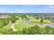 Picturesque aerial shot of a golf course community featuring a pond and well-manicured greens, ideal for golf enthusiasts at 1391 Links Crossing Dr, Monroe, NC 28112