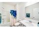 Bright bathroom features a shower and tub combination with striking blue shower curtain and vanity at 1391 Links Crossing Dr, Monroe, NC 28112