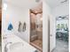 Clean, modern bathroom with a double vanity, glass enclosed shower, and access to the main bedroom at 1391 Links Crossing Dr, Monroe, NC 28112