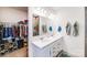 Dual vanity bathroom with closet storage, large mirror, and modern fixtures at 1391 Links Crossing Dr, Monroe, NC 28112