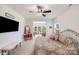 Spacious bedroom with ceiling fan, adjacent sitting area, and an abundance of natural light at 1391 Links Crossing Dr, Monroe, NC 28112