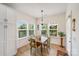 Eat-in dining area with natural light, a wooden table and chairs, and hardwood flooring at 1391 Links Crossing Dr, Monroe, NC 28112