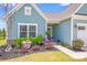 Close up of home entrance featuring tidy landscaping and a walkway at 1391 Links Crossing Dr, Monroe, NC 28112