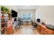 Bright home office featuring two work stations, large windows, and hardwood floors, perfect for a productive workspace at 1391 Links Crossing Dr, Monroe, NC 28112