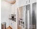Modern kitchen features stainless steel refrigerator with water dispenser and well-lit countertops at 1391 Links Crossing Dr, Monroe, NC 28112