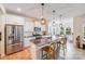 Modern kitchen with island and stainless steel appliances, open to the dining area with lots of light at 1391 Links Crossing Dr, Monroe, NC 28112