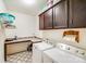 Functional laundry room equipped with modern washer and dryer, ample counter space, and storage cabinets at 1391 Links Crossing Dr, Monroe, NC 28112