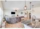 Bright, open-concept living area showcasing a large sofa and modern light fixtures for comfortable and stylish living at 1391 Links Crossing Dr, Monroe, NC 28112