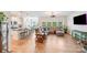 Spacious living room flows to kitchen; features sectional sofa, TV, and ample natural light for seamless living at 1391 Links Crossing Dr, Monroe, NC 28112