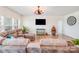 Inviting living room featuring a plush sectional sofa, large TV, and unique barber chair for a cozy atmosphere at 1391 Links Crossing Dr, Monroe, NC 28112