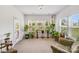Bright sunroom features an array of healthy houseplants and great natural light at 1391 Links Crossing Dr, Monroe, NC 28112