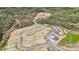 Aerial view shows ongoing construction within the community, surrounded by trees, and includes paved roads at 1487 Hubert Graham Way, Tega Cay, SC 29708