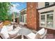 Back deck with outdoor seating area with furniture and a brick exterior at 1545 Chadmore Nw Ln, Concord, NC 28027