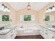 Bright bathroom showcasing garden tub with tile surround, and window with view of lush landscaping at 1545 Chadmore Nw Ln, Concord, NC 28027