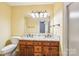 Bathroom with granite counter tops, double sinks, wood cabinets, and tile backsplash at 1545 Chadmore Nw Ln, Concord, NC 28027