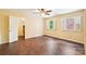 Bedroom with wood floors, windows with views of backyard, and closet with custom shelves at 1545 Chadmore Nw Ln, Concord, NC 28027